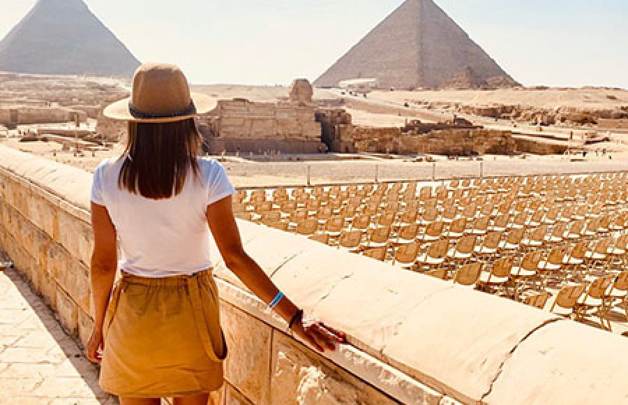 A traveler overlooking the Great Pyramids of Giza during a 12 day Cairo Nile cruise Sharm El Sheikh tour.