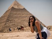 Solo Traveler taking a photo infront of the pyramids