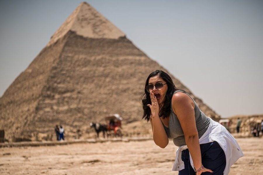 Solo Traveler taking a photo infront of the pyramids