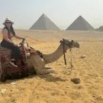 Giza Pyramids Female Traveler Riding Camel At Giza Plateau