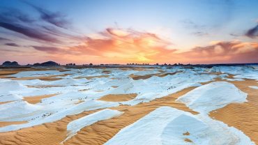 Farafra Oasis is a serene desert oasis in Egypt known for its white desert landscape, picturesque palm groves, and natural hot springs.