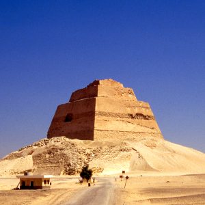 The Meidum Pyramid, an ancient Egyptian structure, stands tall with its step-like appearance, showcasing early pyramid construction techniques.