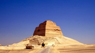 The Meidum Pyramid, an ancient Egyptian structure, stands tall with its step-like appearance, showcasing early pyramid construction techniques.