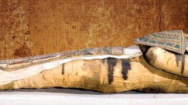 Ancient mummification process involving meticulous preservation of the body through embalming and wrapping techniques.