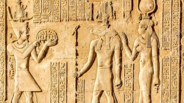 A detailed view of ancient Egyptian art depicting intricate hieroglyphs, vibrant wall paintings, and majestic sculptures.