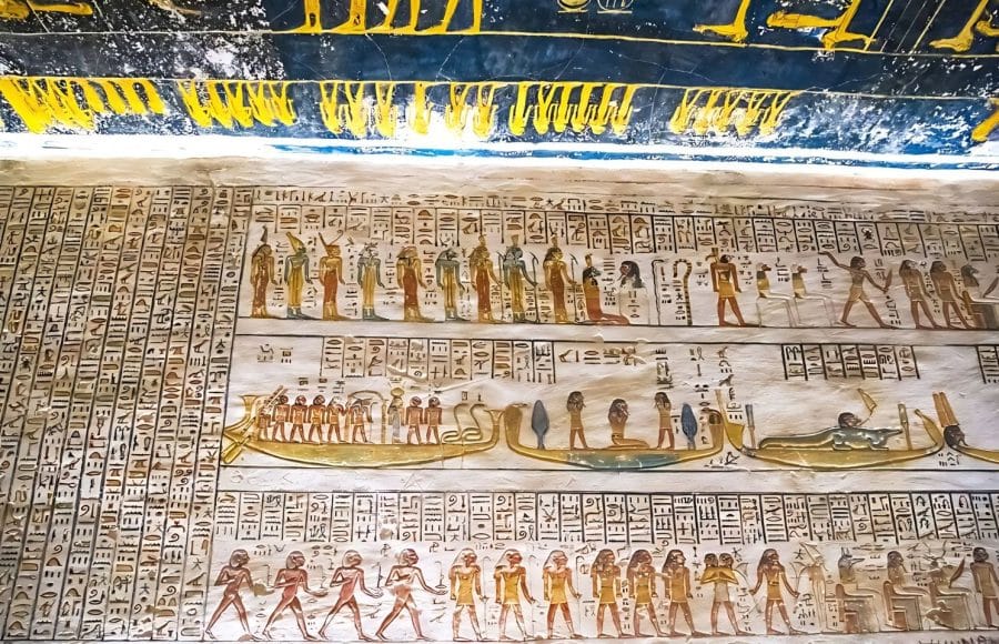 Detailed and brightly colored hieroglyphs and religious scenes cover the walls of an Ancient Burial Chambers for Pharaohs with Hieroglyphics at the Valley of the Kings Luxor, showcasing the artistry of ancient Egyptian tombs.