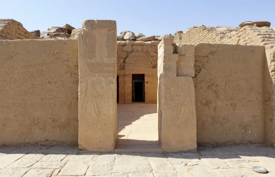 The entrance to the rock-cut temple of Beit el-Wali, showing two central pillars with carved relief figures of Ramses II.