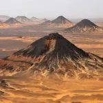 Panoramic view of the volcanic black hills in the Black Desert near Bahariya Oasis.