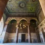 An upward view of the beautifully decorated, multi-colored and gilt wooden Ceiling Mosque of Sultan Barquq Complex, featuring geometric and calligraphic designs.