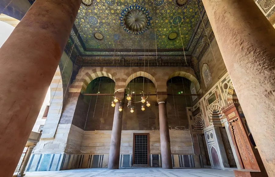 An upward view of the beautifully decorated, multi-colored and gilt wooden Ceiling Mosque of Sultan Barquq Complex, featuring geometric and calligraphic designs.