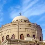 Close-up view of the distinctive dome and cross of the Church of St. George in Old Cairo.