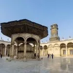 The large, decorative fountain and courtyard of the Mohamed Ali Mosque, which is located inside the historic Citadel of Cairo.