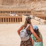 Family viewing the terraced Mortuary Temple of Hatshepsut, built into the cliffs near the Valley of the Kings in Luxor.