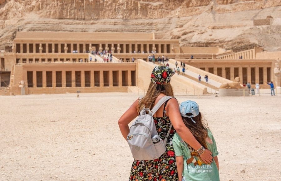 Family viewing the terraced Mortuary Temple of Hatshepsut, built into the cliffs near the Valley of the Kings in Luxor.
