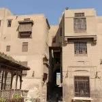 The traditional, stone architecture of the Gayer Anderson Museum Cairo, showing the exterior walls and traditional wooden mashrabiya windows.