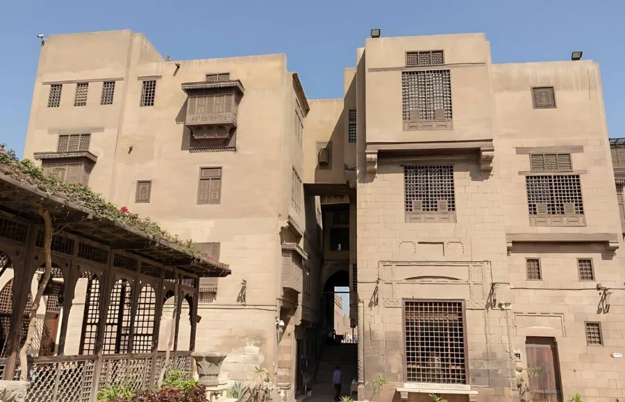 The traditional, stone architecture of the Gayer Anderson Museum Cairo, showing the exterior walls and traditional wooden mashrabiya windows.
