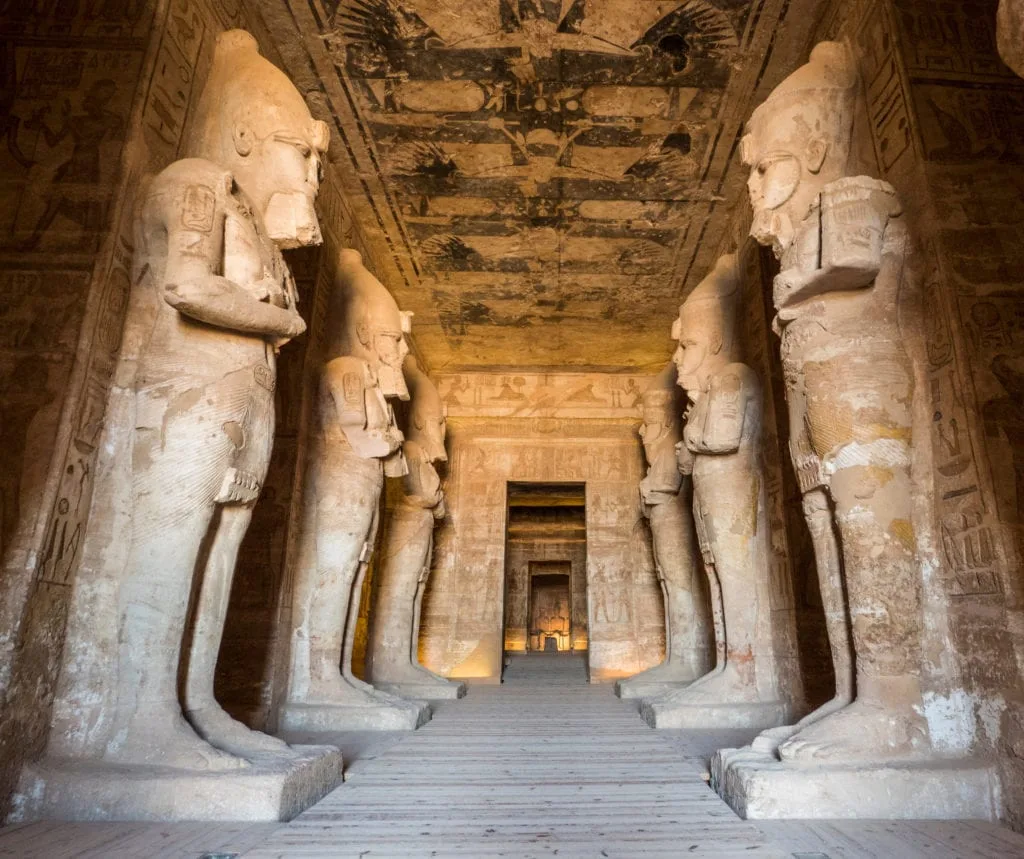 A group of statues in a building Inside Abu Simbel Temple - Nile Cruise Cairo Abu Simbel