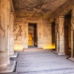 The interior of the Inside the Small Temple of Ramesses II Abu Simbel, showing columns carved with the likenesses of Queen Nefertari, and well-preserved reliefs and hieroglyphics on the walls.