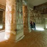 Temple of Amada in Nubia, showing large, square pillars covered in brightly painted, detailed hieroglyphic reliefs.