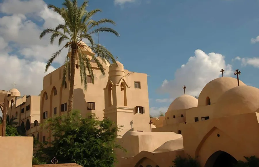 Traditional architecture and palm trees at the Monastery of Deir al Suryani (Monastery of the Syrians) in Wadi El Natrun.