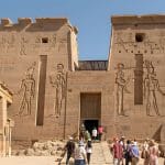 Small group tour entering the majestic Temple of Isis at Philae Island Aswan Egypt