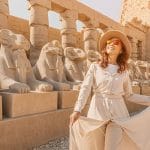 Woman tourist exploring the Avenue of Sphinxes in Karnak Temple Luxor Egypt ancient architecture