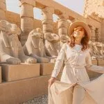 Woman tourist exploring the Avenue of Sphinxes in Karnak Temple Luxor Egypt ancient architecture