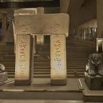 Massive ancient Egyptian statues and artifacts on display in the brightly lit, modern entrance hall during The Grand Egyptian Museum Tour.