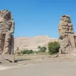 The two colossal, seated statues of Pharaoh Amenhotep III, known as the Colossi of Memnon.