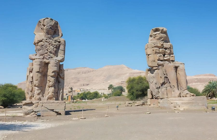 The two colossal, seated statues of Pharaoh Amenhotep III, known as the Colossi of Memnon.