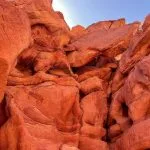 The intricate red and orange sandstone rock formations in a desert canyon.