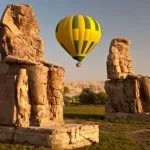 Hot air balloon flight over ancient Egyptian Colossi of Memnon Luxor sunrise photography