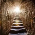 Sunlit temple passage with steps flanked by ancient Egyptian hieroglyphs Edfu Temple interior