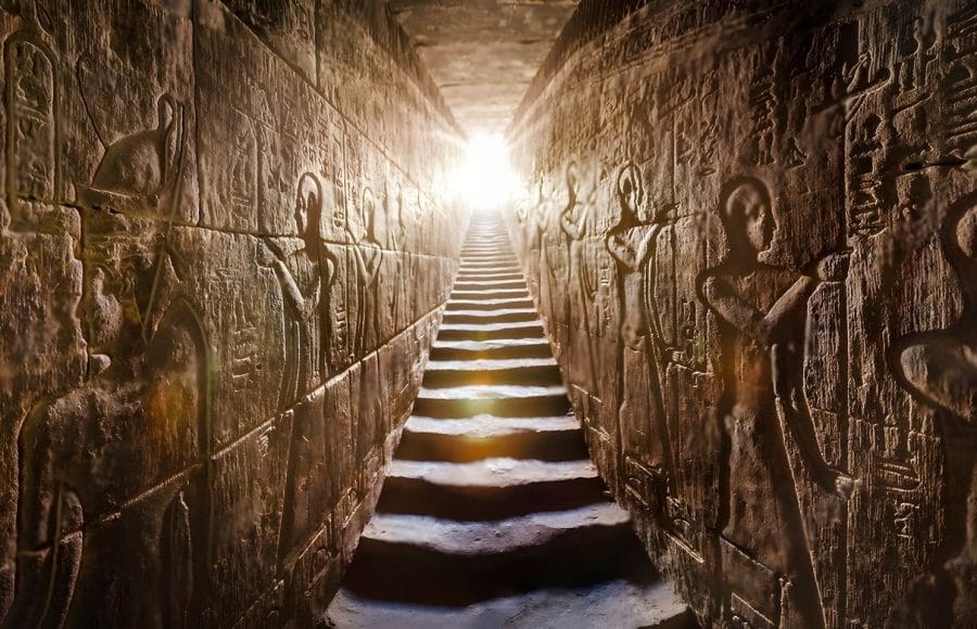 Sunlit temple passage with steps flanked by ancient Egyptian hieroglyphs Edfu Temple interior