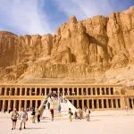 Travelers at Temple of Hatshepsut, with its three terraced levels and grand ramps, is nestled on the West Bank of Luxor.