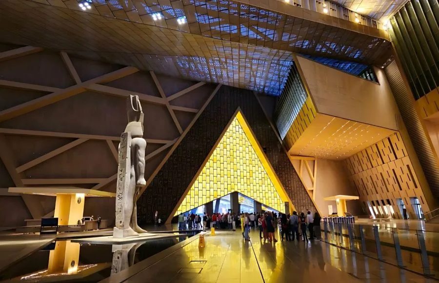 The Grand Egyptian Museum (GEM) lobby with a large ancient Egyptian statue.