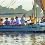 People-On-An-Excursion-On-The-Nile-River-In-Felucca-Traditional-Wooden-Sailing-Boat-Tripidays-Egypt-Tours