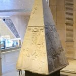 Ancient granite pyramidion capstone with hieroglyphs on display inside the Grand Egyptian Museum GEM Giza