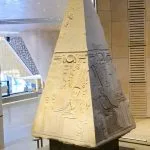 Ancient granite pyramidion capstone with hieroglyphs on display inside the Grand Egyptian Museum GEM Giza