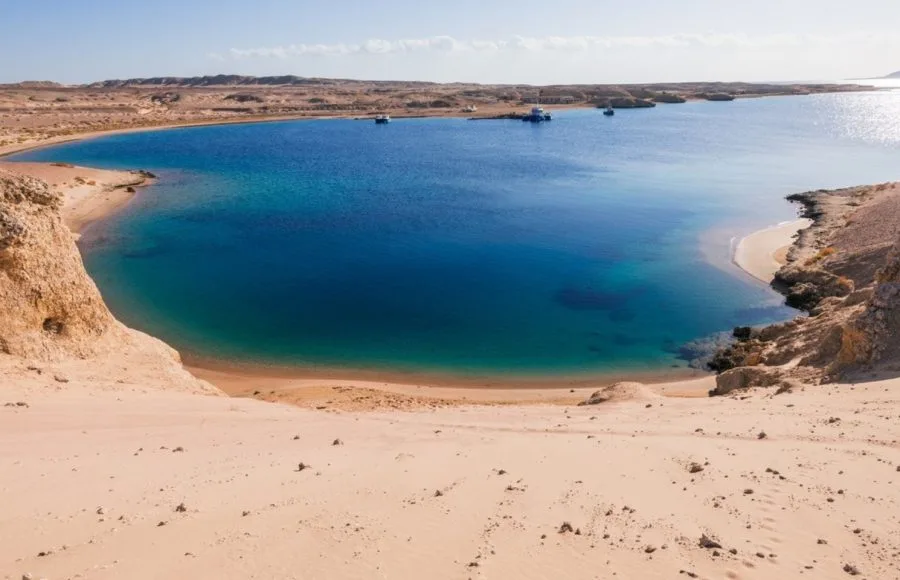 Deep blue coastal bay and sandy beach, typical of the landscapes within Ras Mohammed National Park.
