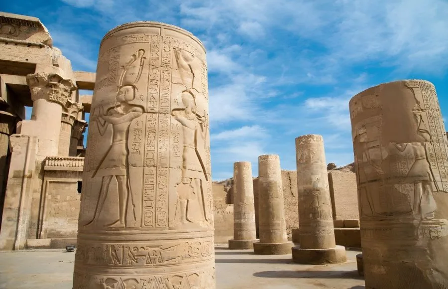 A close-up view of a massive column carved with hieroglyphs, showing the detail of the Temple of Sobek and Haroeris Kom Ombo.