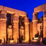The Great Peristyle Court of Ramesses II illuminated at night in Luxor Temple