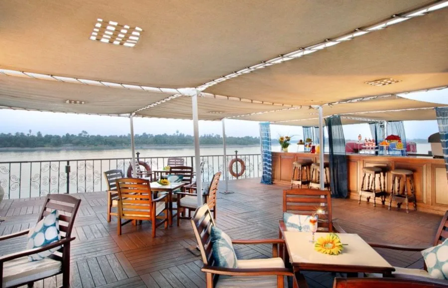 The shaded sun deck bar and seating area overlooking the Nile on the luxurious MS Miriam nile cruise ship