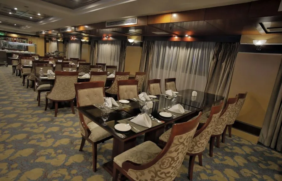The spacious and bright restaurant on the Blue Shadow i Nile Cruise, with a buffet counter and dining tables.