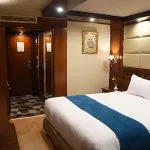 A clean and modern cabin with two single beds on the Blue Shadow II Nile cruise.