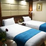A clean and modern cabin with two single beds on the Blue Shadow II Nile cruise