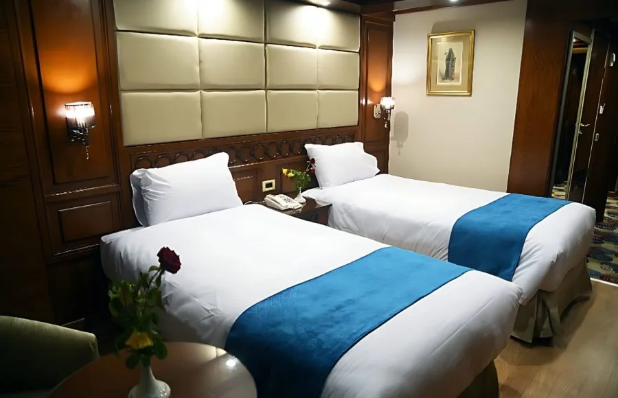A clean and modern cabin with two single beds on the Blue Shadow II Nile cruise