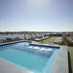 The sunny top deck of the Blue Shadow II Nile cruise ship, showing a swimming pool and lounge chairs.