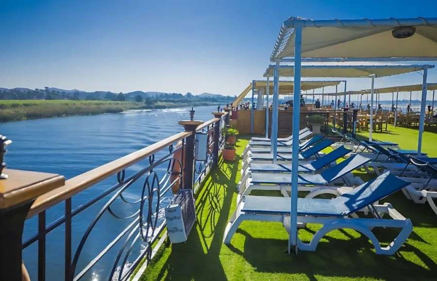 Blue Shadow iii Nile Cruise upper sun deck, with a row of lounge chairs and the railing overlooking the tranquil Nile River.
