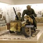 Dioramas and a World War II-era military motorcycle with a sidecar, manned by mannequins, are displayed Inside the El Alamein War Museum in Egypt.